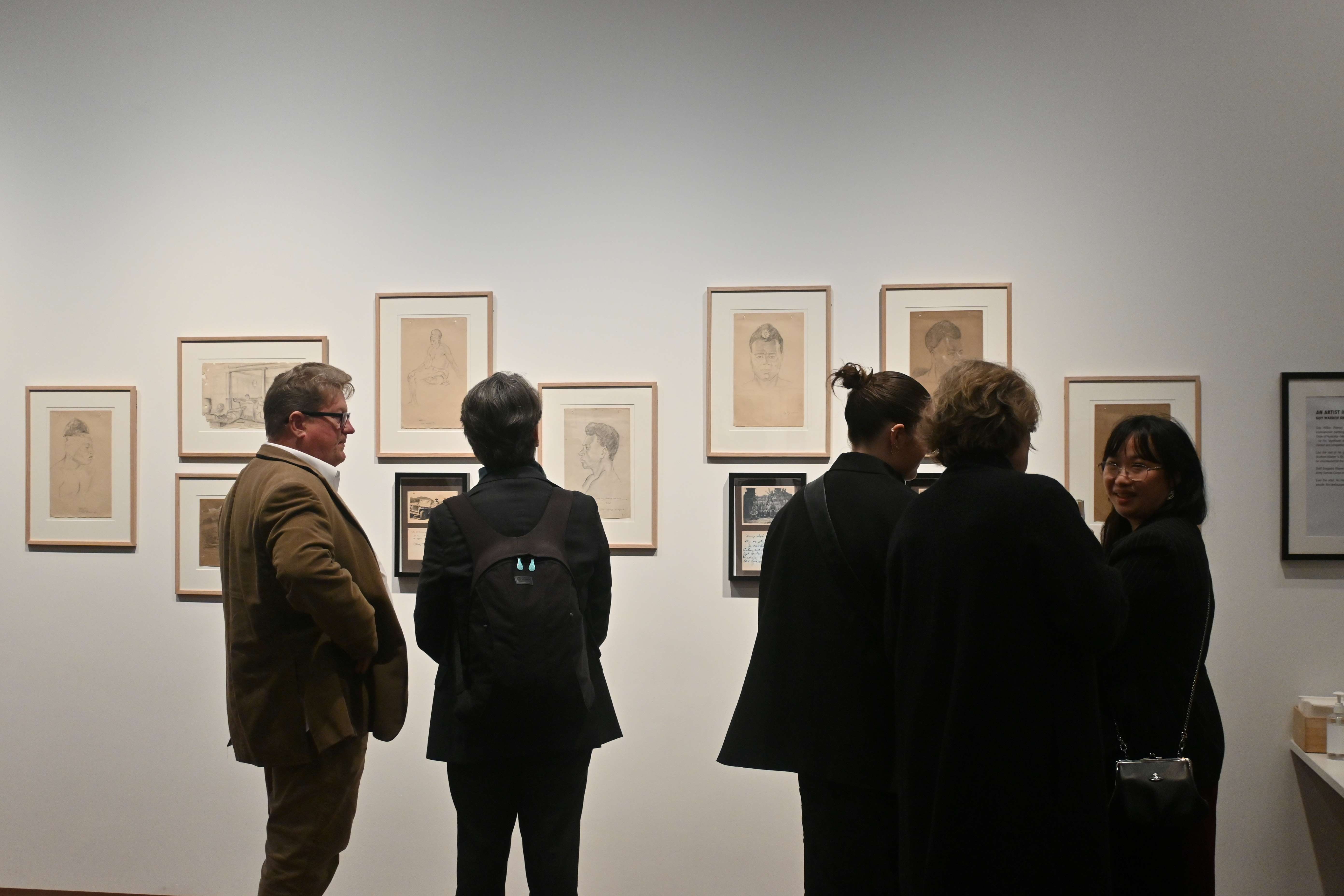 Attendees viewing the exhibition.