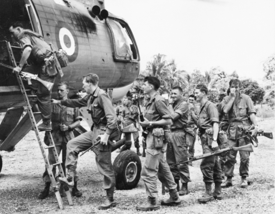 A 3RAR patrol climbs aboard a RAF Belvedere helicopter for insertion to an ambush position on the border of Kalimantan during Confrontation. AWM P01706.003.